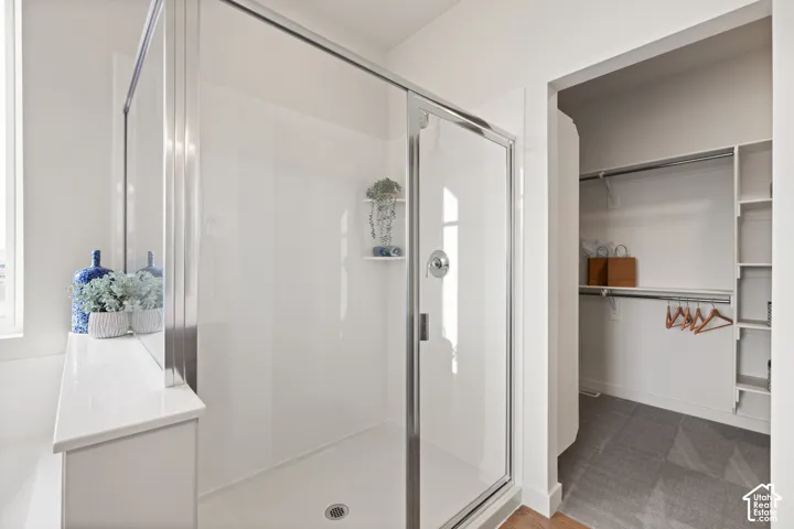 Glass-enclosed shower with a chrome shower fixture