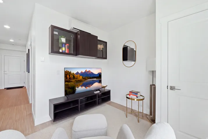 Integrated media console with wall-mounted storage cabinetry and a wall-mounted AC unit