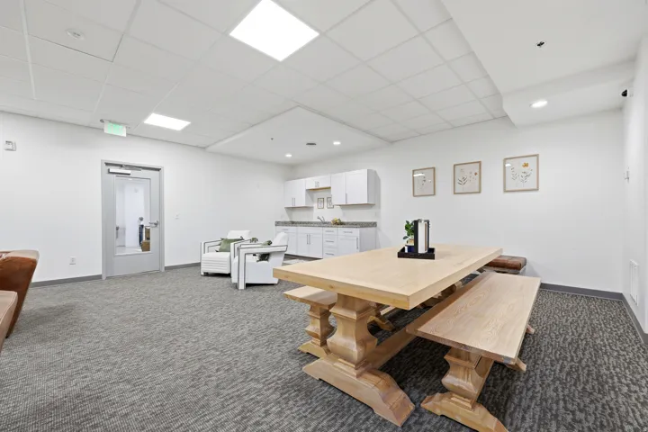 Recessed lighting, wood-finish flooring, white cabinetry, and a light-colored countertop