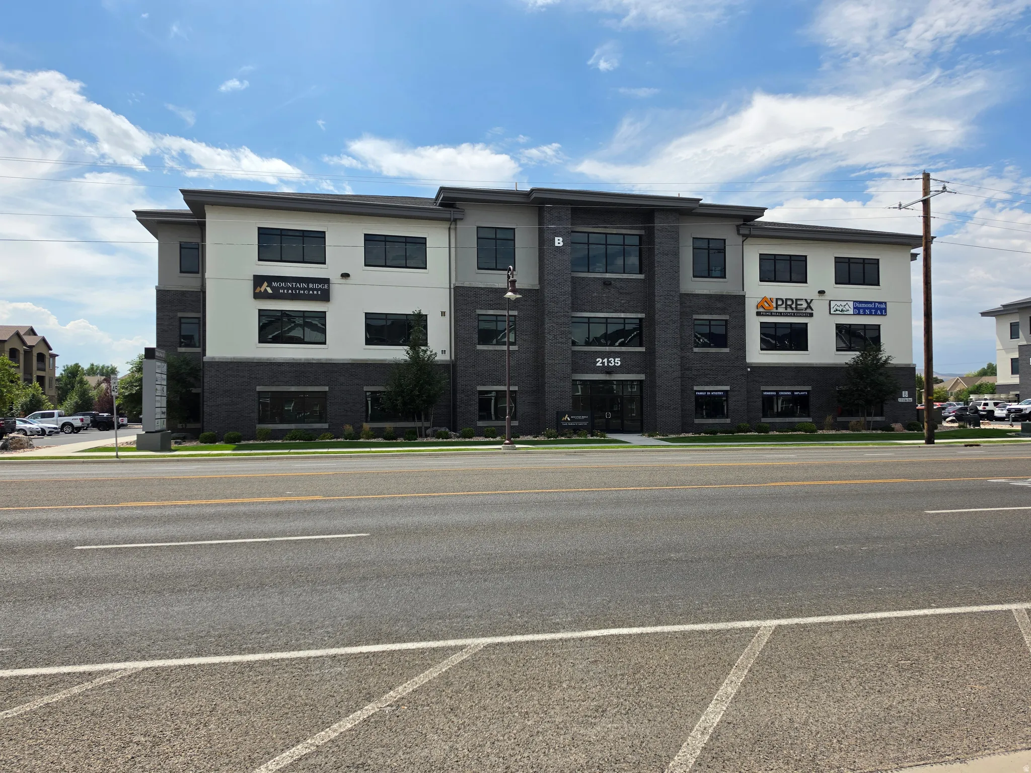 Modern commercial building featuring a multi-tone facade, ample window coverage, and dedicated tenant signage