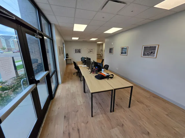 Expansive wood-finish flooring, full-height windows, and recessed lighting