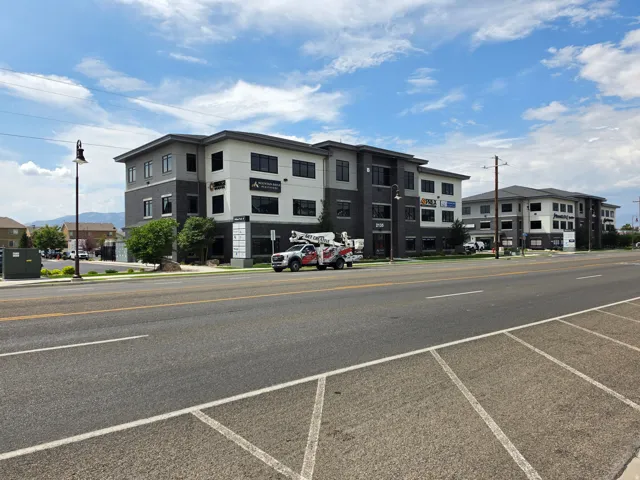 Modern commercial building with a multi-story design, large window installations, and a prominent street-facing presence