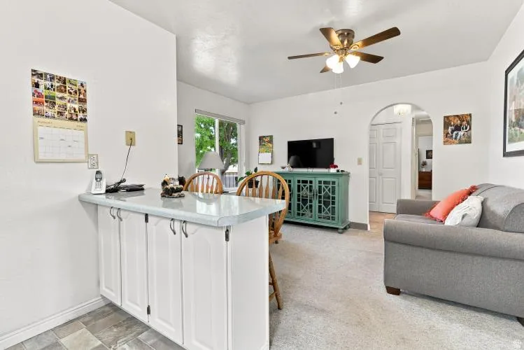 Built-in breakfast bar with white cabinetry and a light-toned countertop
