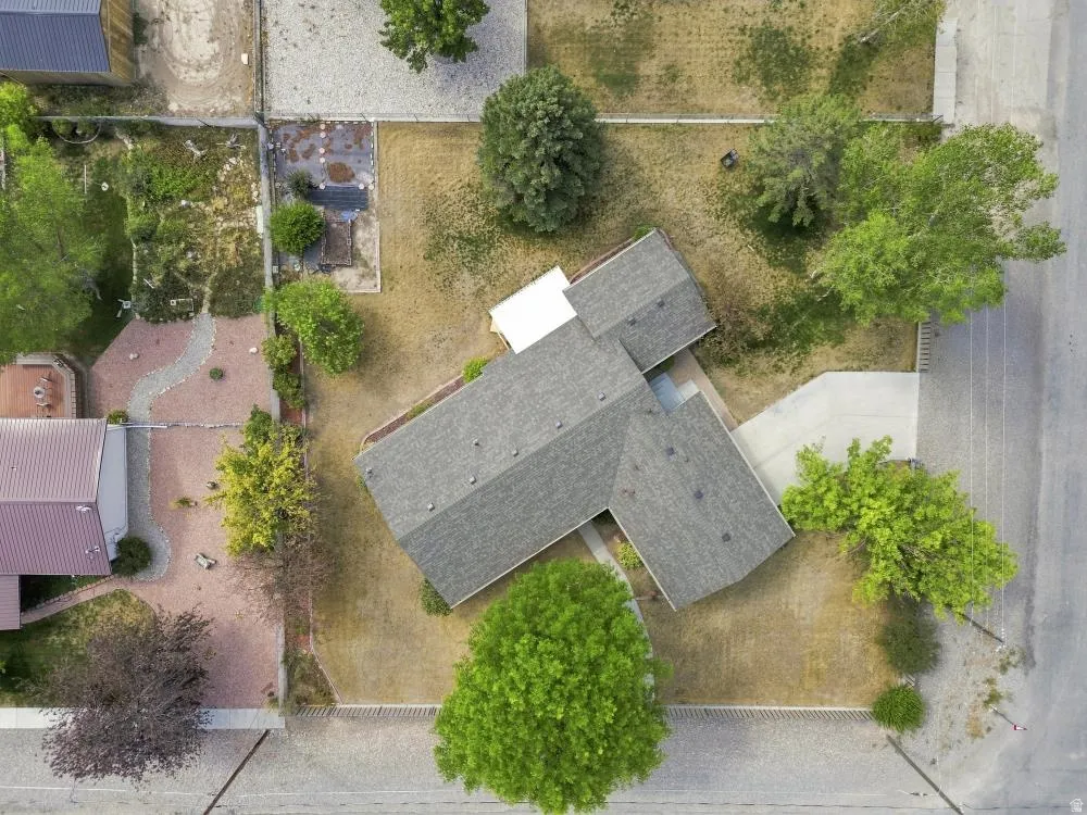 Two-story residential structure with a shingle roof and a concrete driveway
