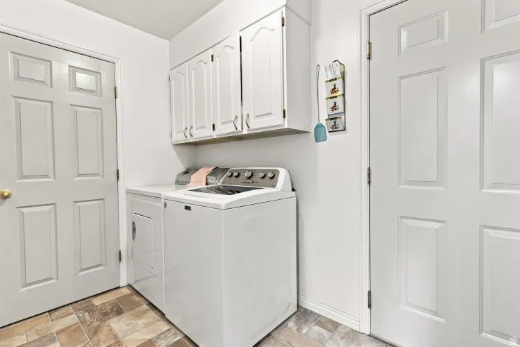 Hard surface flooring, white paneled doors, and upper cabinetry