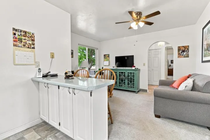 Built-in breakfast bar with white cabinetry and a light-toned countertop