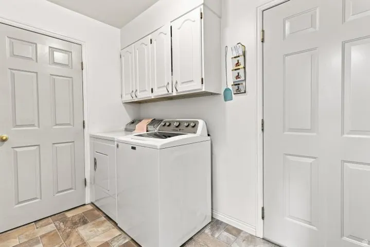 Hard surface flooring, white paneled doors, and upper cabinetry