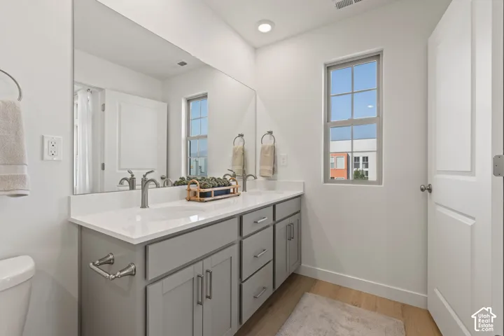 Dual vanity with light gray cabinetry, brushed nickel hardware, and white countertops