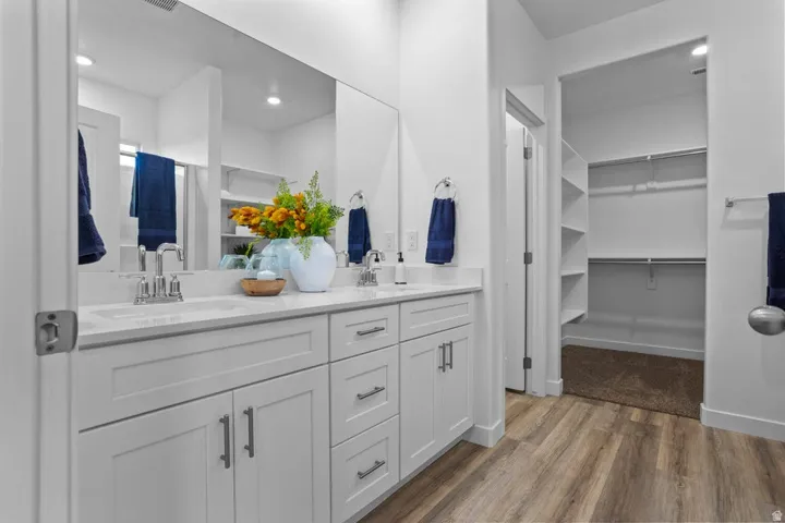 Dual vanity with white shaker cabinetry and integrated sinks