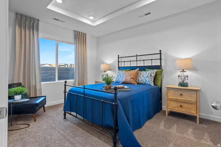 Recessed lighting, tray ceiling, large window with natural light, wall-to-wall carpeting, and light-toned walls