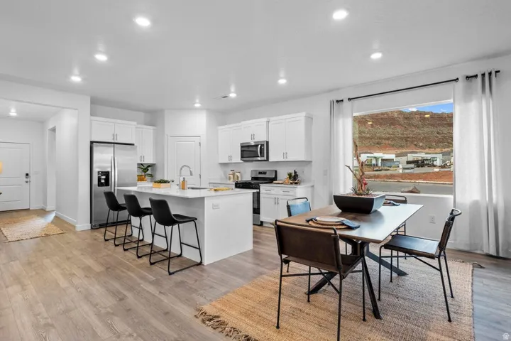 Modern kitchen with white cabinetry and stainless steel appliances