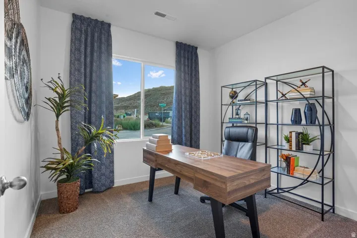 Recessed lighting, large window with ample natural light, and carpeted flooring