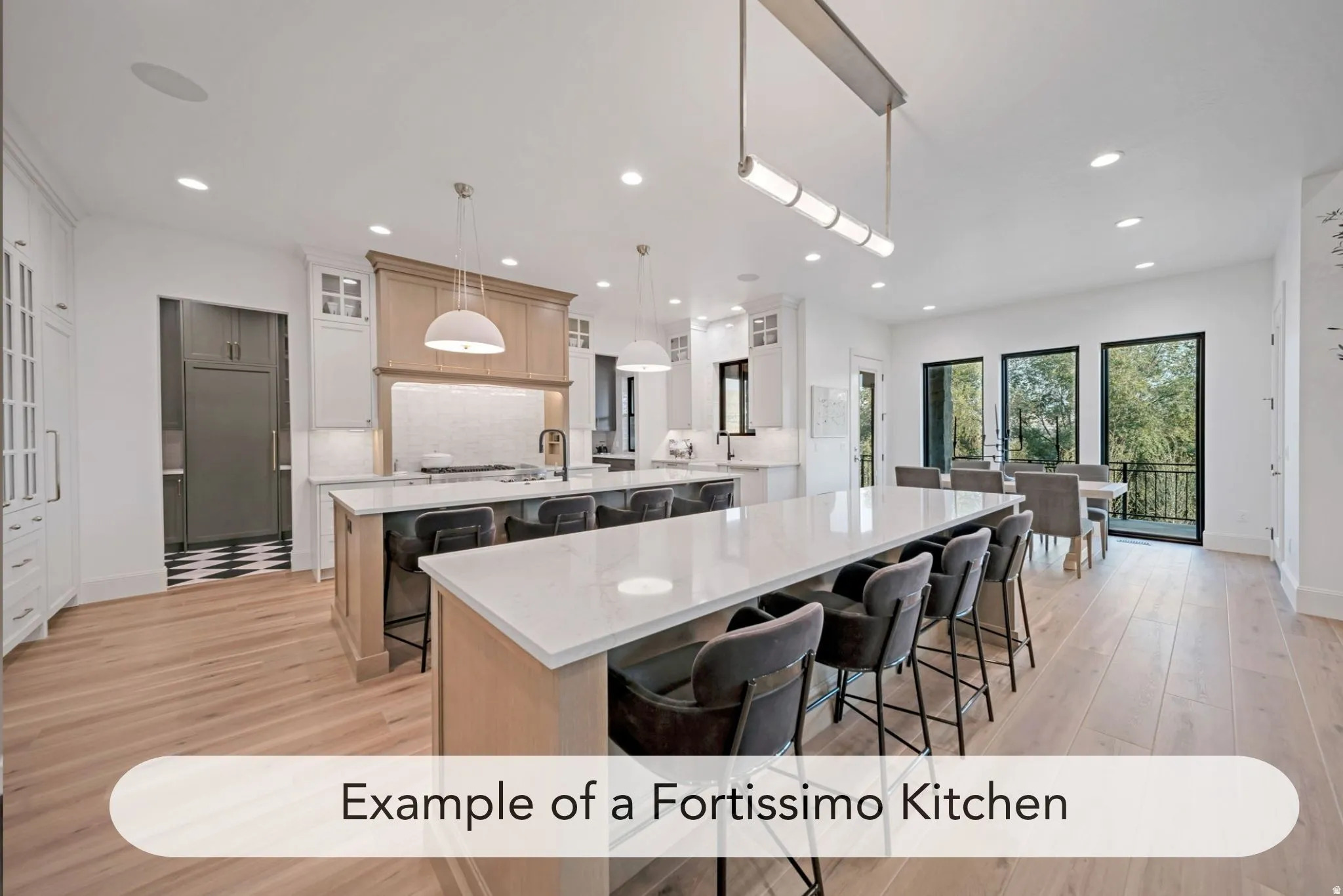 Expansive kitchen and dining area featuring light wood-finish flooring, recessed lighting, and a kitchen island with a light-colored countertop