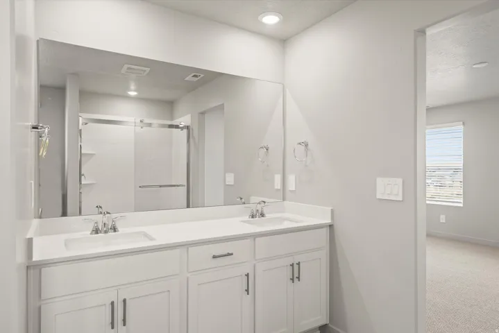 **DISCLAIMER**   Interior package upgrades not photographed. Dual vanity with undermount sinks, quartz countertop, and chrome fixtures
