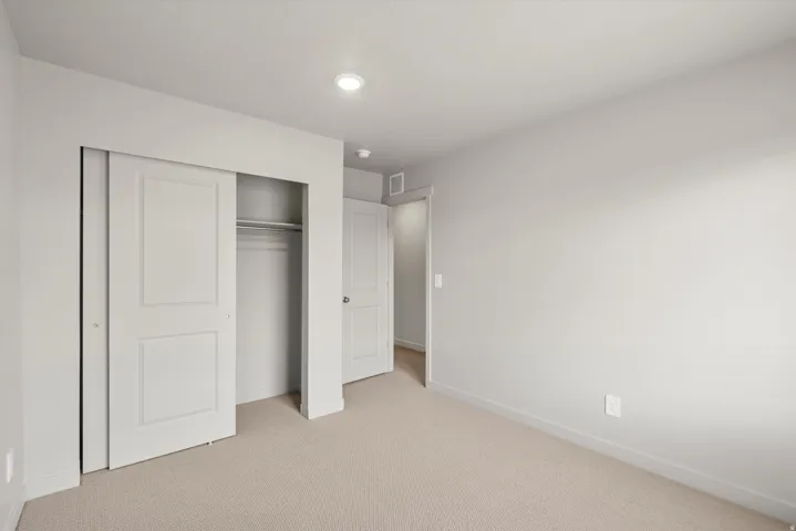 **DISCLAIMER**   Interior package upgrades not photographed. Recessed lighting, light-colored carpeting, white interior doors, and a closet with sliding doors