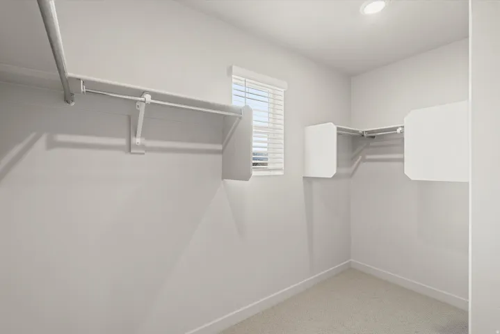 **DISCLAIMER**   Interior package upgrades not photographed. Built-in shelving and hanging rods, recessed ceiling lighting, textured carpet flooring, and a window with blinds