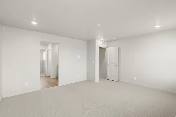 **DISCLAIMER**   Interior package upgrades not photographed. Spacious room with light-toned carpeting and recessed lighting
