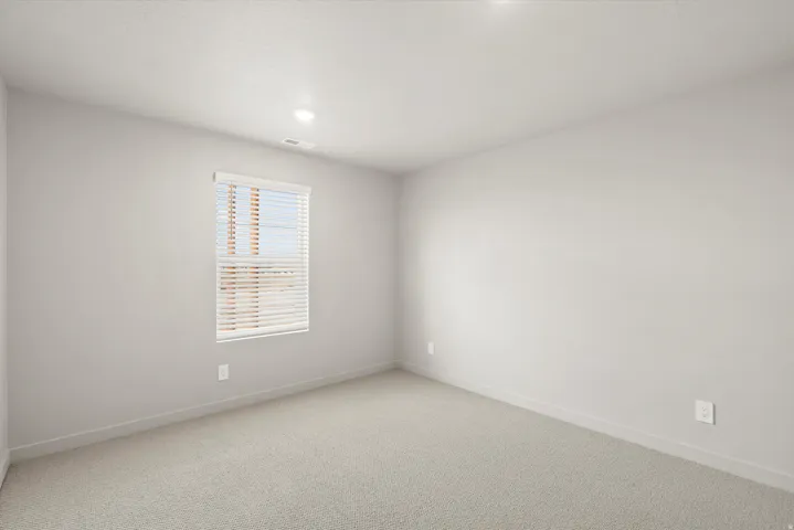 **DISCLAIMER**   Interior package upgrades not photographed. Recessed lighting, light-toned carpeting, and a window with horizontal blinds