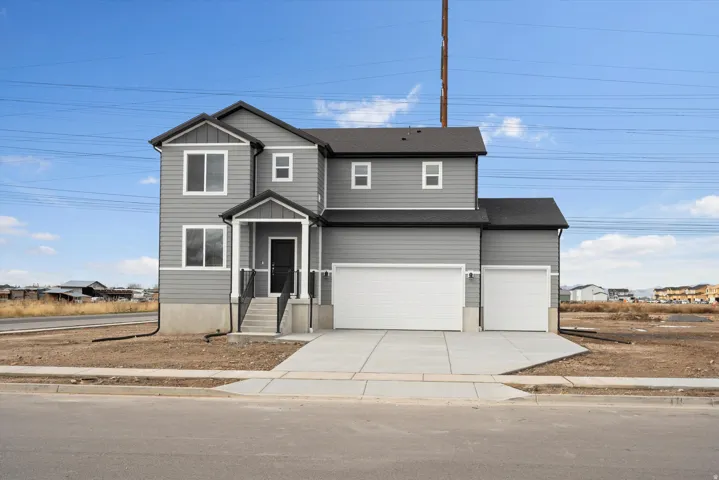 **DISCLAIMER** Elevation may vary.  Two-story residence featuring gray siding, a covered entry, and a multi-car garage