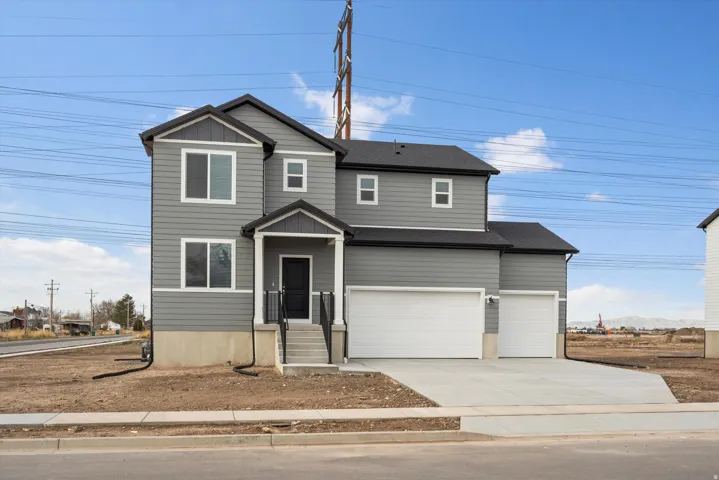 **DISCLAIMER** Elevation may vary.  Two-story dwelling with gray siding, black shingle roof, and white window trim