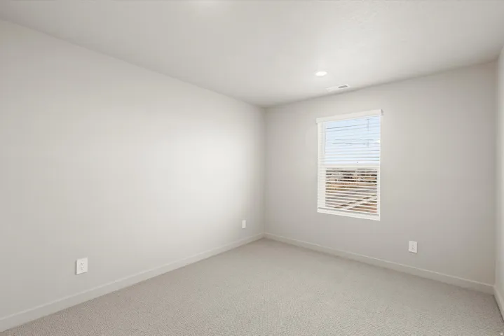**DISCLAIMER**   Interior package upgrades not photographed. Recessed ceiling light, neutral-toned walls, light-colored carpeting, single window with blinds, white trim