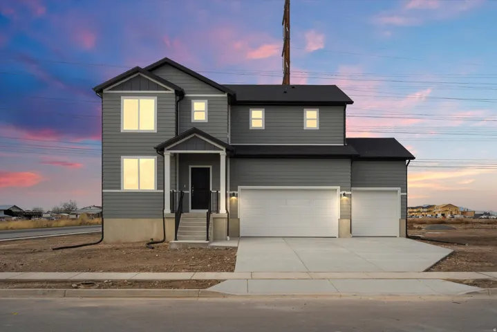 **DISCLAIMER** Elevation may vary.  Two-story facade with horizontal siding, covered entry, and attached two-car garage