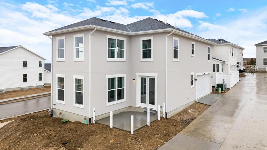 Modern two-story stucco exterior with a dark shingle roof