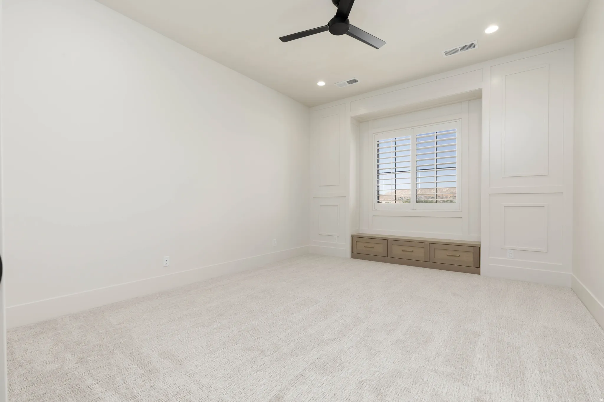 Recessed lighting, ceiling fan, built-in window seat, integrated drawers, and window shutters
