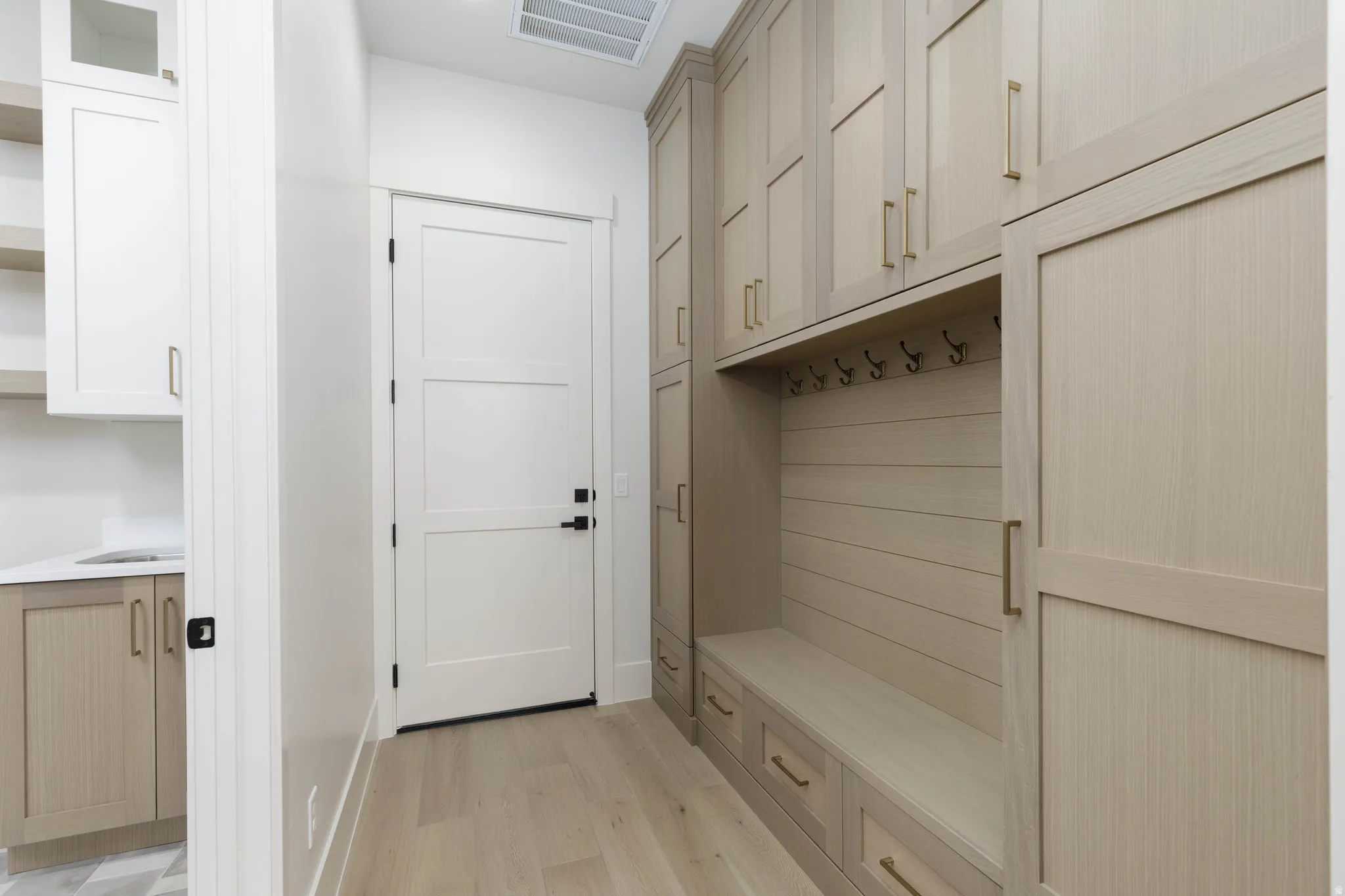 Built-in mudroom bench with integrated storage and coat hooks