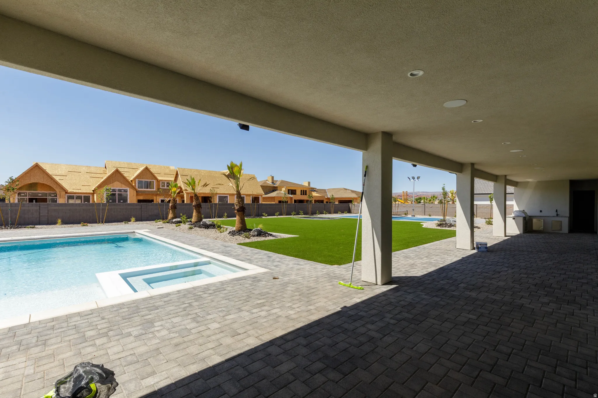 Covered patio with recessed lighting, paver flooring, and built-in outdoor kitchen