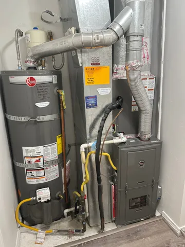 Water heater and furnace systems with associated ductwork and piping