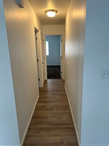 Wood-finish flooring throughout the hallway