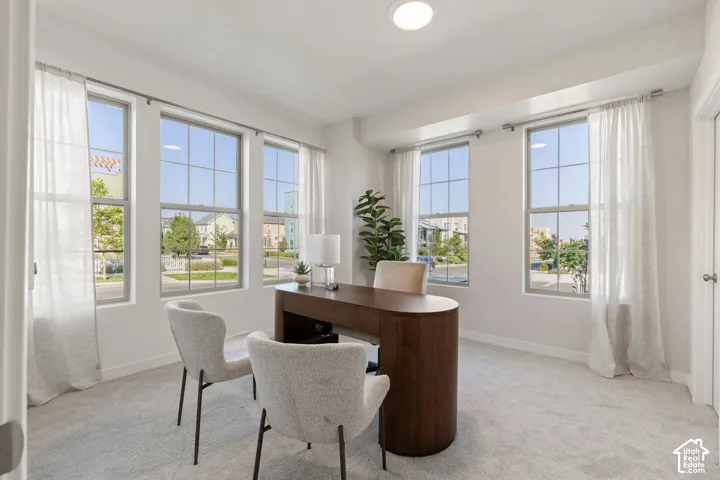 Recessed ceiling lighting, white walls, light-toned carpet, and multiple grid-pattern windows