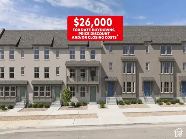 Multi-story townhome exterior featuring shingle roofing, paneled siding, bay windows, and private balconies