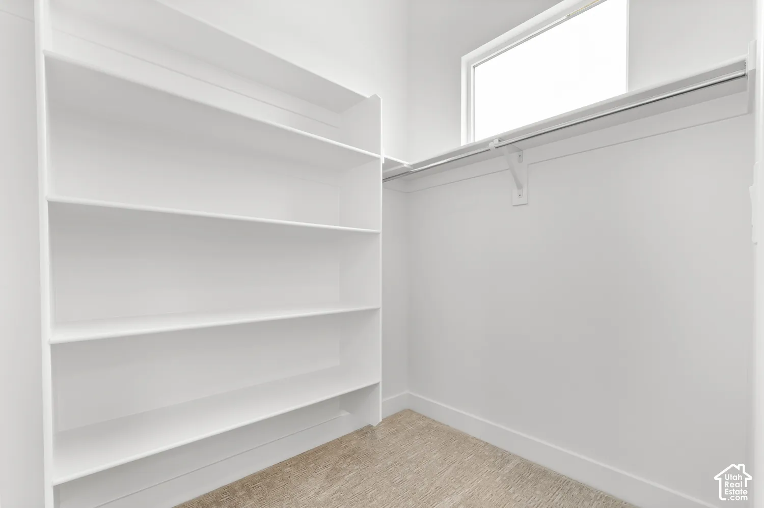 Integrated shelving, upper storage rod, and natural light from transom window