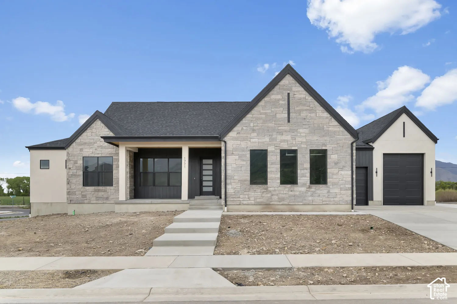 Contemporary exterior featuring stone and stucco finishes