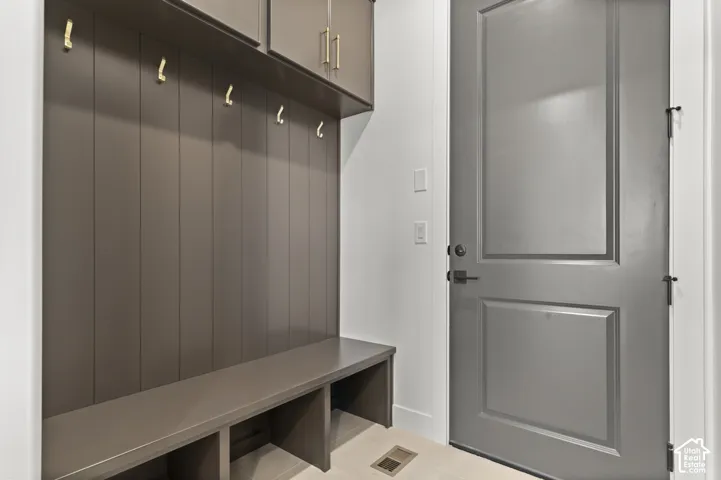 Built-in storage bench with individual cubbies and wall paneling