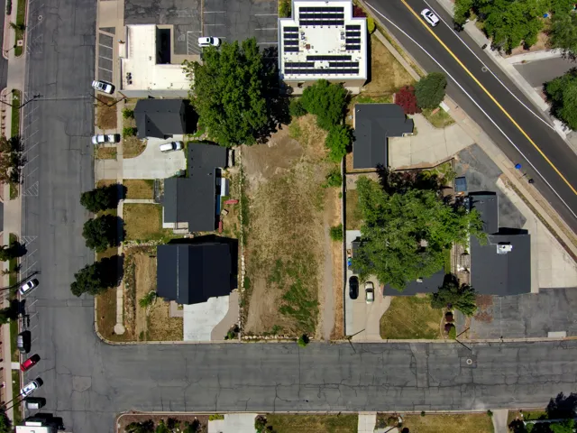 Expansive lot with established surrounding properties, concrete paved street access, and a clear, level building area