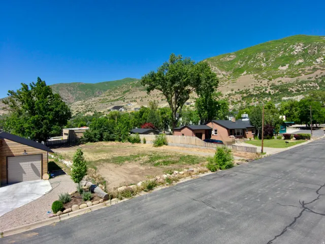 Expansive lot with mountain backdrop and established surrounding properties