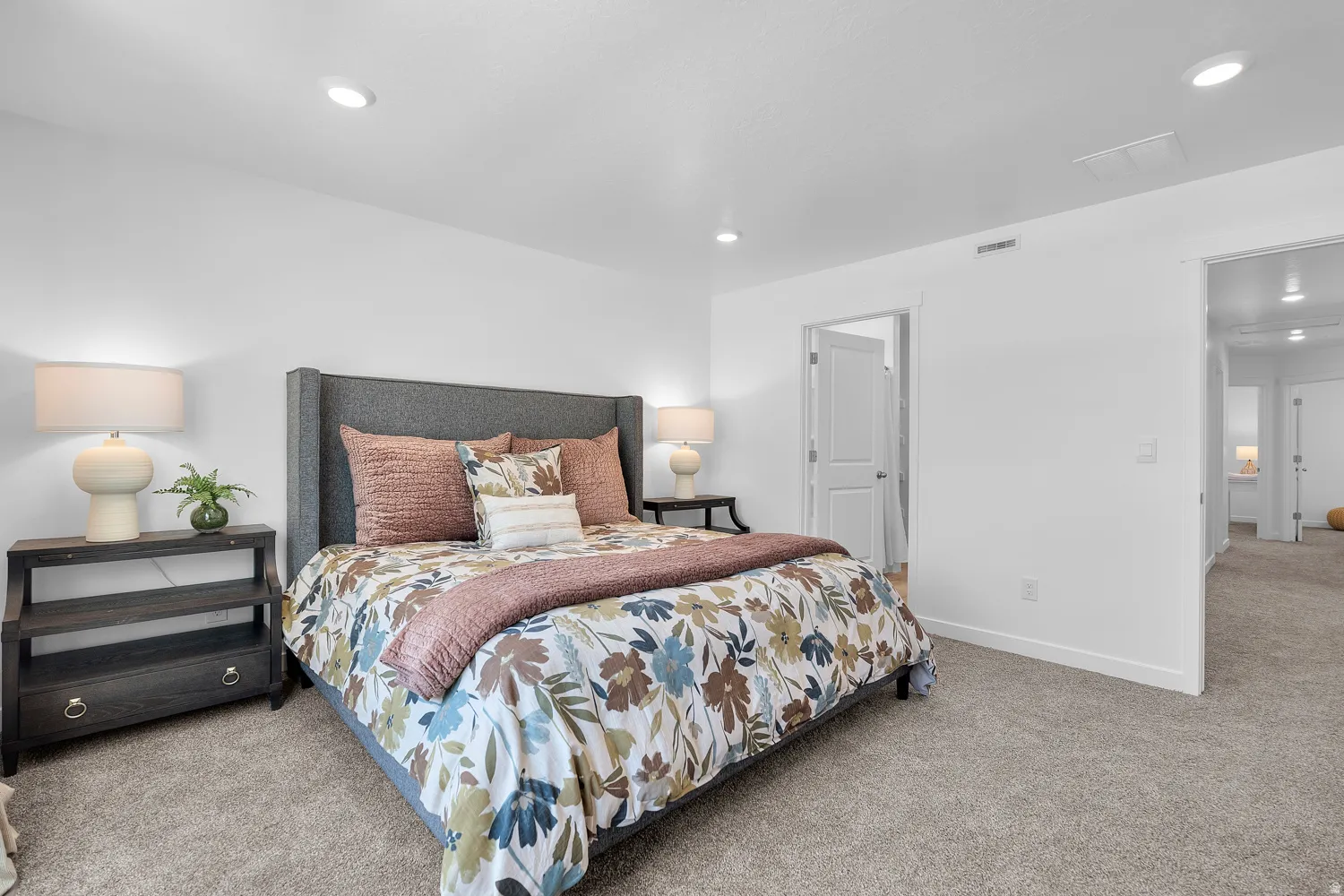 Recessed ceiling lighting, white walls, gray carpet flooring, white trim, and white doors