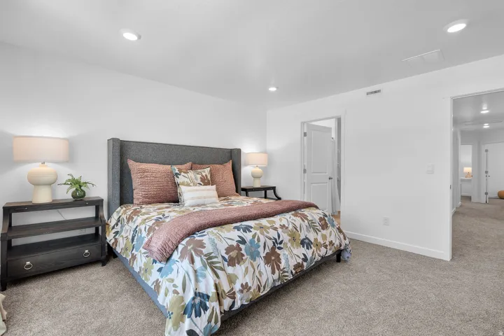 Recessed ceiling lighting, white walls, gray carpet flooring, white trim, and white doors