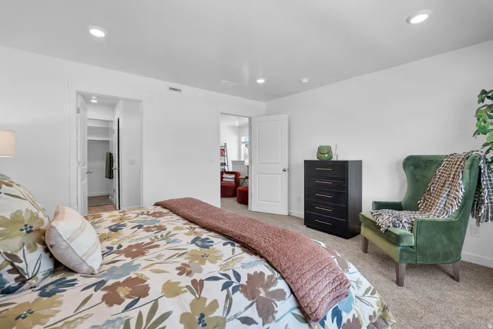 Recessed ceiling lighting, white interior doors, and carpeted flooring