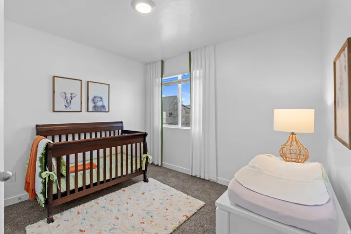 Recessed ceiling light, white walls, carpeted flooring, window with white trim, and white baseboards