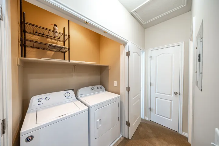 Laundry alcove featuring a built-in shelf and wire shelving