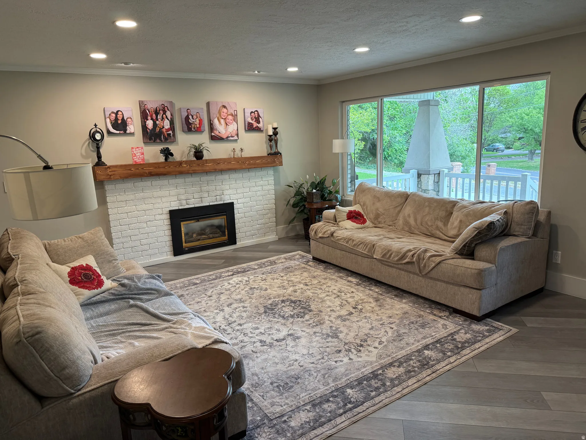 White brick fireplace with a wood mantel