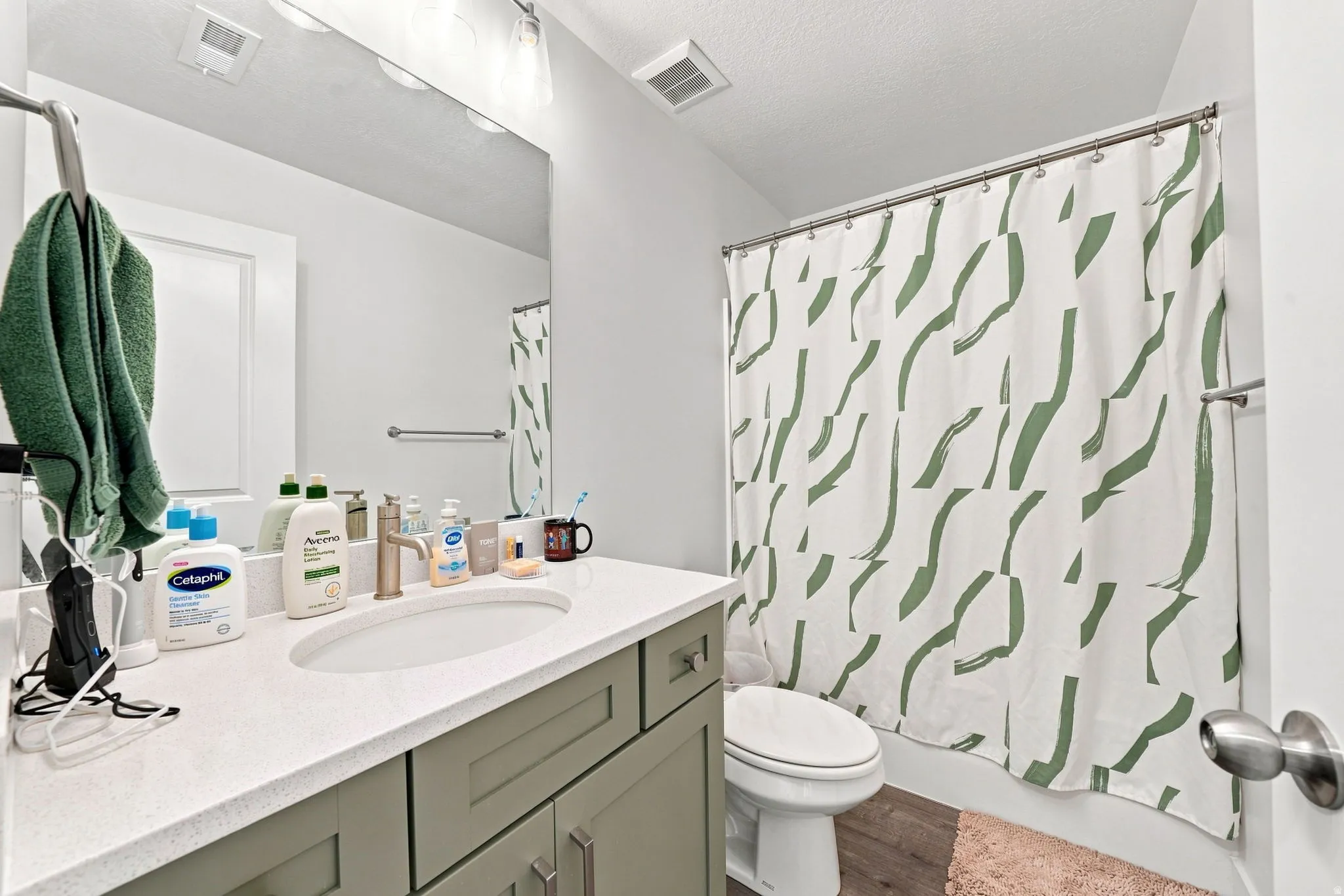 Vanity with a light-colored countertop, recessed sink, and brushed brass-finish faucet