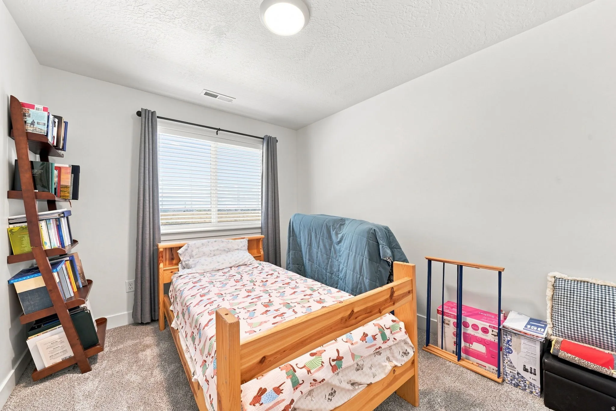 Recessed ceiling light, wall-to-wall carpeting, and a window with blinds