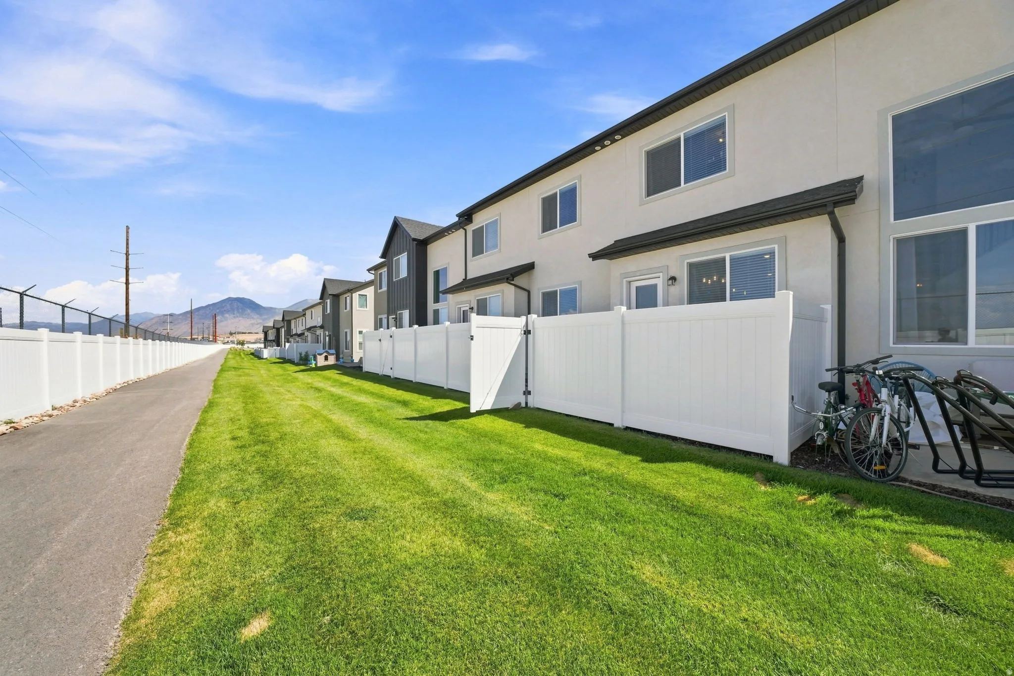 Private patio area featuring a white vinyl fence