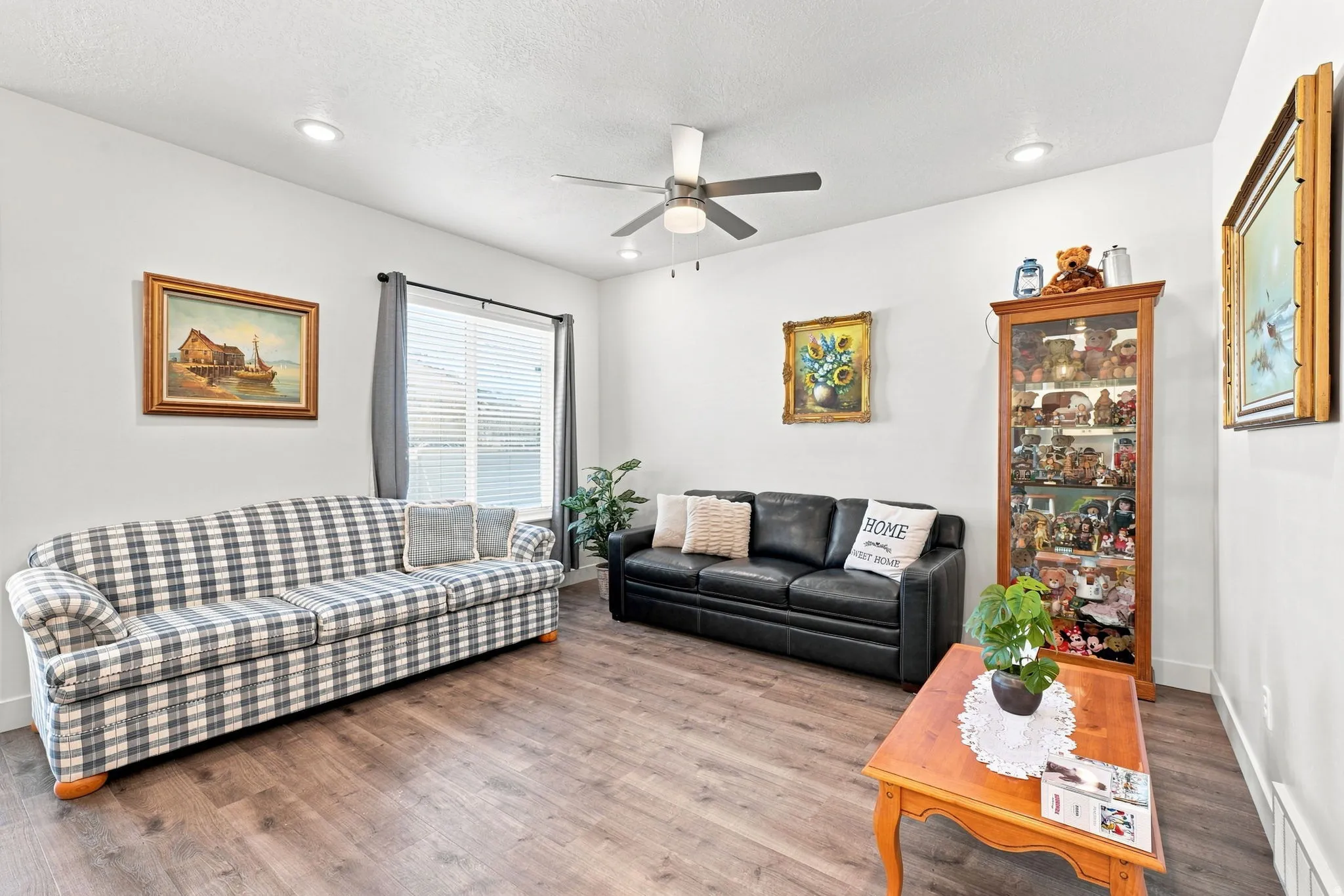 Recessed lighting, wood-finish flooring, ceiling fan, natural light from a window, and a built-in display cabinet