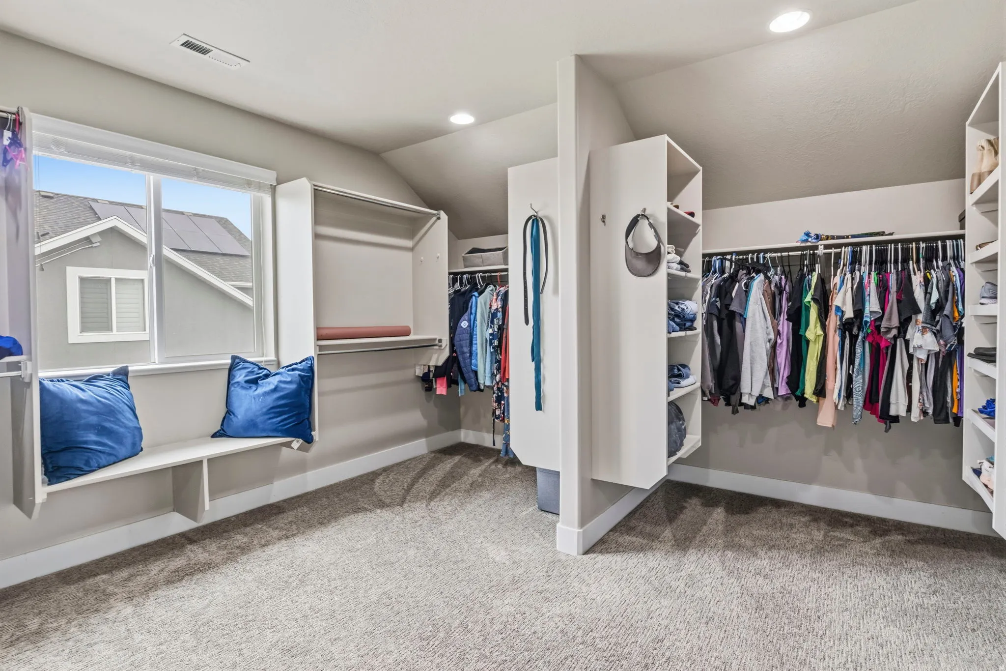 Built-in closet organization with hanging rods and shelving